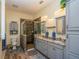 Well-lit bathroom featuring a spacious walk-in shower with glass enclosure, double sinks, and granite countertops at 14365 Evans Ranch Rd, Lakeland, FL 33809