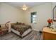 Bedroom featuring wood look floors, a ceiling fan, and a bright window at 14365 Evans Ranch Rd, Lakeland, FL 33809