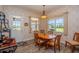 Cozy dining area with natural light, wood table and chairs, and charming pendant lighting at 14365 Evans Ranch Rd, Lakeland, FL 33809