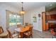 Inviting dining area with wood table, natural light, and access to the kitchen at 14365 Evans Ranch Rd, Lakeland, FL 33809