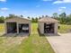 Two large garages with ample space for vehicle and equipment storage, set on a well-maintained lawn at 14365 Evans Ranch Rd, Lakeland, FL 33809