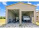 Large metal garage with two open bays showcasing ample space for vehicle and equipment storage at 14365 Evans Ranch Rd, Lakeland, FL 33809