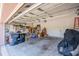 Untidy garage featuring tools, equipment, and storage, offering potential for a functional workspace at 14365 Evans Ranch Rd, Lakeland, FL 33809