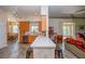 Open kitchen featuring a bar counter, wood cabinets, and access to dining and living areas at 14365 Evans Ranch Rd, Lakeland, FL 33809