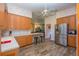 Spacious kitchen with stainless steel refrigerator, wood cabinetry, bar counter, and ample counter space at 14365 Evans Ranch Rd, Lakeland, FL 33809