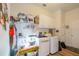 Bright laundry room with white cabinetry, modern washer and dryer, and storage shelves for organization at 14365 Evans Ranch Rd, Lakeland, FL 33809