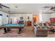 Open-concept living area featuring a pool table, comfortable sofa, and access to other areas at 14365 Evans Ranch Rd, Lakeland, FL 33809