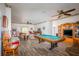 Spacious living room with a billiards table, comfortable seating, and a ceiling fan at 14365 Evans Ranch Rd, Lakeland, FL 33809