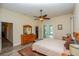 Bright main bedroom with wood floors, ceiling fan, walk in closet and access to outdoor pool area at 14365 Evans Ranch Rd, Lakeland, FL 33809