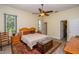 Bright main bedroom featuring a ceiling fan, wood look floors, and a comfortable atmosphere at 14365 Evans Ranch Rd, Lakeland, FL 33809
