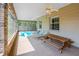 Relaxing outdoor area featuring an in-ground pool, lounge chairs, and a rustic wooden picnic table at 14365 Evans Ranch Rd, Lakeland, FL 33809