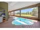 Covered deck area boasting an outdoor spa with views of the green backyard at 14365 Evans Ranch Rd, Lakeland, FL 33809