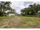 Expansive backyard with lush greenery, storage shed, and plenty of space for recreation at 1816 W Lake Parker Dr, Lakeland, FL 33805