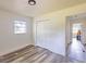 Simple bedroom with ample natural light and wood-look flooring at 1816 W Lake Parker Dr, Lakeland, FL 33805