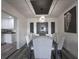 Elegant dining area boasts a modern light fixture, unique wall decor, and seating for six guests at 1816 W Lake Parker Dr, Lakeland, FL 33805