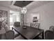 Modern dining room features decorative screens, a striking light fixture, and stylish, upholstered chairs at 1816 W Lake Parker Dr, Lakeland, FL 33805