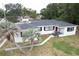 Aerial view of a single-story home with palm trees and a well-maintained lawn at 1816 W Lake Parker Dr, Lakeland, FL 33805