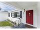 Inviting front porch with a red door and 'Home Sweet Home' mat at 1816 W Lake Parker Dr, Lakeland, FL 33805