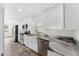 Bright kitchen showcases white cabinets, stainless steel appliances, and a farmhouse sink with marble countertops at 1816 W Lake Parker Dr, Lakeland, FL 33805