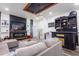 Cozy living room featuring a large television, custom bar, and comfortable sectional seating area at 1816 W Lake Parker Dr, Lakeland, FL 33805
