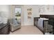 Comfortable bedroom with dark wood crib, dresser, neutral walls and plush accent chair at 2076 Babbling Brook Blvd, Auburndale, FL 33823