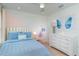 Bright bedroom featuring pastel colors, butterfly wall art, and a cozy bed with decorative pillows at 2076 Babbling Brook Blvd, Auburndale, FL 33823