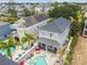 Aerial view of a two-story home with a pool, hot tub, patio, and manicured landscaping at 7523 Excitement Dr, Kissimmee, FL 34747