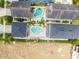 Aerial view of backyards with pools and patios between houses, roofs, and a bit of grass at 7523 Excitement Dr, Kissimmee, FL 34747