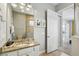 Bathroom featuring a large mirror, granite vanity, and tiled shower with glass door at 7523 Excitement Dr, Kissimmee, FL 34747