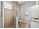 Neutral bathroom featuring a tiled shower with glass door and a granite vanity top at 7523 Excitement Dr, Kissimmee, FL 34747