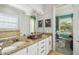 Bathroom featuring a granite countertop with double sinks and plenty of cabinet space at 7523 Excitement Dr, Kissimmee, FL 34747
