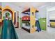 Whimsical ' bedroom featuring a slide, bunk beds, and playful cartoon wall decor at 7523 Excitement Dr, Kissimmee, FL 34747