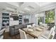 A modern dining room features a coffered ceiling, chandelier, and sliding glass doors to the backyard at 7523 Excitement Dr, Kissimmee, FL 34747