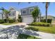 Exterior two-story house featuring a white garage, paved driveway, and landscaped yard at 7523 Excitement Dr, Kissimmee, FL 34747