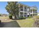 Charming two-story home showcasing a large tree and expansive lawn at 7523 Excitement Dr, Kissimmee, FL 34747