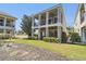 Exterior view of a two-story home with a covered patio and balcony, plus a lawn at 7523 Excitement Dr, Kissimmee, FL 34747