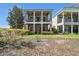 Two-story house with pillars, balconies, landscaped yard, and exterior view at 7523 Excitement Dr, Kissimmee, FL 34747