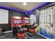 Game room with motorcycle arcade games and a custom mural at 7523 Excitement Dr, Kissimmee, FL 34747