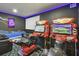Arcade game room with a large movie screen and motorcycle games at 7523 Excitement Dr, Kissimmee, FL 34747