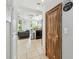 Hallway that leads into the kitchen and features tiled floors and an accent door at 7523 Excitement Dr, Kissimmee, FL 34747