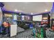 Home theater with tiered seating, movie posters, and a wet bar at 7523 Excitement Dr, Kissimmee, FL 34747