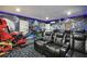 Theater room with tiered seating, arcade games and themed decor at 7523 Excitement Dr, Kissimmee, FL 34747