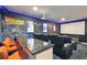 Home theater room featuring a large screen, comfortable seating, and unique decor at 7523 Excitement Dr, Kissimmee, FL 34747