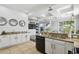 Eat-in kitchen with granite counters, stainless appliances, white cabinets, and backyard view at 7523 Excitement Dr, Kissimmee, FL 34747