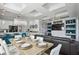 Open concept living and dining area with modern decor, hardwood floors, and barstool seating at 7523 Excitement Dr, Kissimmee, FL 34747