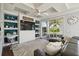 This living room features a built-in shelving, a ceiling fan, and sliding glass doors at 7523 Excitement Dr, Kissimmee, FL 34747