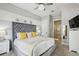 Bedroom features a tufted headboard and ensuite bathroom at 7523 Excitement Dr, Kissimmee, FL 34747