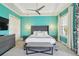Tranquil main bedroom with tray ceiling, designer lighting, and cool turquoise walls, offering luxury at 7523 Excitement Dr, Kissimmee, FL 34747