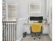 Landing area with a built-in desk, yellow chair, and multiple windows for natural light at 7523 Excitement Dr, Kissimmee, FL 34747