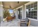Covered patio with comfortable seating, ceiling fans, and sliding glass doors for seamless indoor-outdoor living at 7523 Excitement Dr, Kissimmee, FL 34747